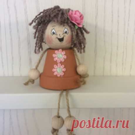 Flower pot people  These are cute flower pot dolls made using a terracotta flower pot,wooden head,string for the arms and legs,wool for their hair and a pretty paper rose in their hair. Hair colour is brown and the face expression will be a random pick of smiley,surprise...