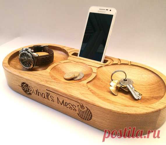 Phone Stand, Charging Station. Triple bowls,watch stand. Personalised. Solid oak with cable route for charger. Superb Fathers Day present! Phone stand in oak. Charging Station which includes three bowls for change, wallet, keys etc. The left hand bowl also includes a watch stand post. Superb Gift for Him and Fathers Day (the one in the gallery was created for a keen golfer, for example)  Dimensions: 365mm x 160mm x 50mm